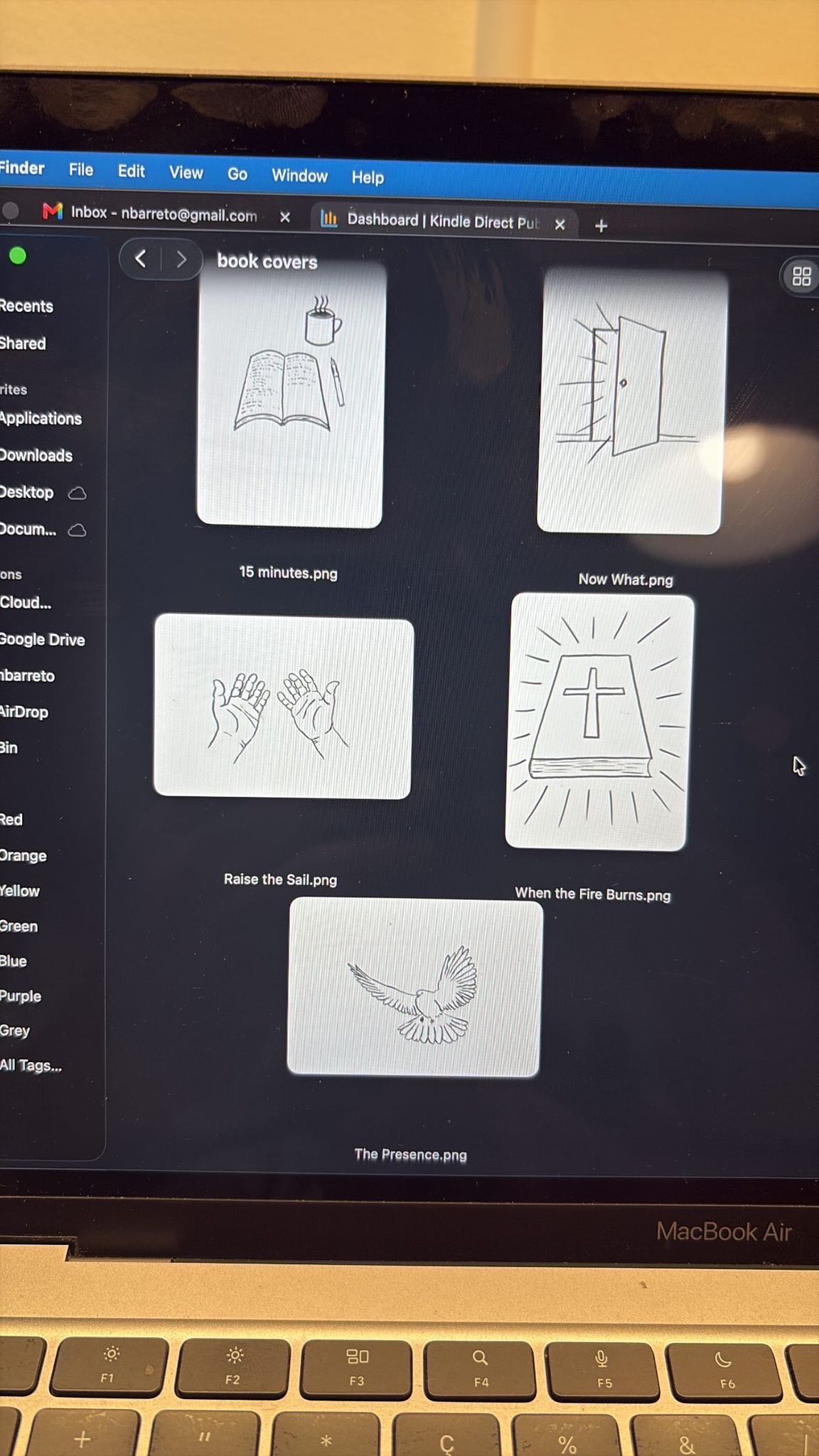 Five of the finished cover drawings open on a computer screen with backgrounds removed